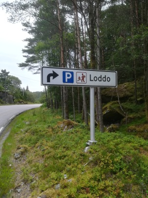 Signpost for a walker's car park, Norway. NOTE: the walking logo includes a tree!